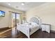 Bright bedroom with hardwood floors and French doors leading to balcony at 10125 E Cortez Dr, Scottsdale, AZ 85260