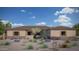 Single-story home with desert landscaping, and a light beige stucco exterior at 12313 E Gold Dust Ave, Scottsdale, AZ 85259