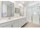 Bathroom with double vanity, large mirror and walk-in shower at 17040 W Echo Ln, Waddell, AZ 85355