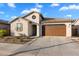 House exterior with a brown garage door and desert landscaping at 17040 W Echo Ln, Waddell, AZ 85355