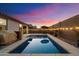 Inviting rectangular pool with a large patio and string lights at 17040 W Echo Ln, Waddell, AZ 85355