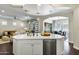 Large kitchen island with seating, a sink, and a view of the living area at 1771 E Alegria Rd, San Tan Valley, AZ 85140