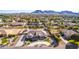 Aerial view of a house with circular driveway and landscaped yard, mountain backdrop at 21121 E Marsh Rd, Queen Creek, AZ 85142