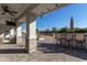 Covered patio with seating area, stone pillars, and views of the backyard at 21121 E Marsh Rd, Queen Creek, AZ 85142
