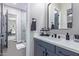 Modern bathroom with gray vanity and a large mirror at 21121 E Marsh Rd, Queen Creek, AZ 85142