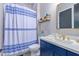 Modern bathroom with blue vanity, white countertop and shower at 21121 E Marsh Rd, Queen Creek, AZ 85142