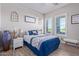 Spacious bedroom with a queen-size bed and large windows at 21121 E Marsh Rd, Queen Creek, AZ 85142