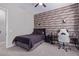 Guest bedroom with wood-look walls, a bed, and a workspace at 21121 E Marsh Rd, Queen Creek, AZ 85142