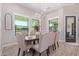 Bright dining room features a large wooden table and six upholstered chairs at 21121 E Marsh Rd, Queen Creek, AZ 85142