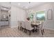Bright dining room features a large wooden table and six upholstered chairs at 21121 E Marsh Rd, Queen Creek, AZ 85142