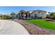 Home exterior with artificial turf and a long driveway at 21121 E Marsh Rd, Queen Creek, AZ 85142