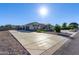 Home exterior with a three-car garage and basketball court at 21121 E Marsh Rd, Queen Creek, AZ 85142