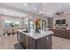 Open floor plan features a large kitchen island and flows into the dining and living areas at 21121 E Marsh Rd, Queen Creek, AZ 85142