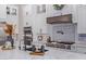 Modern kitchen features a gas cooktop, custom range hood, and white cabinetry at 21121 E Marsh Rd, Queen Creek, AZ 85142