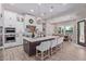 Modern kitchen with large island, stainless steel appliances, and white cabinetry at 21121 E Marsh Rd, Queen Creek, AZ 85142