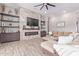 Open living space with a stone fireplace and built-in shelving at 21121 E Marsh Rd, Queen Creek, AZ 85142