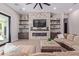 Open living space with a stone fireplace and built-in shelving at 21121 E Marsh Rd, Queen Creek, AZ 85142