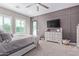 Main bedroom with a dresser, large TV, and access to the backyard at 21121 E Marsh Rd, Queen Creek, AZ 85142