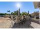 Outdoor kitchen with bar seating, grill, and umbrella at 21121 E Marsh Rd, Queen Creek, AZ 85142