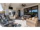 Covered patio with comfortable seating and a large TV at 21121 E Marsh Rd, Queen Creek, AZ 85142
