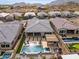 Aerial view of the house, highlighting the backyard oasis with a pool, spa, and pergola at 21354 W Minnezona Ave, Buckeye, AZ 85396