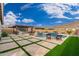 Relaxing backyard with a sparkling pool, patio, and mountain views at 21354 W Minnezona Ave, Buckeye, AZ 85396