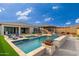Stunning backyard with a sparkling pool, spa, and built-in fire features at 21354 W Minnezona Ave, Buckeye, AZ 85396