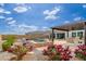 Landscaped backyard with pool, spa, and lush flowering plants at 21354 W Minnezona Ave, Buckeye, AZ 85396