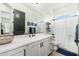 Clean bathroom with white cabinets, a white countertop, and a walk-in shower at 21354 W Minnezona Ave, Buckeye, AZ 85396