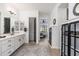Bright bathroom with double vanity, and view into bedroom at 21354 W Minnezona Ave, Buckeye, AZ 85396
