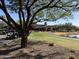 Community clubhouse near a pond, with golf carts parked nearby at 21354 W Minnezona Ave, Buckeye, AZ 85396