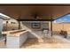 Relaxing covered patio with outdoor kitchen and ceiling fan at 21354 W Minnezona Ave, Buckeye, AZ 85396