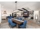 Dining room with a large wooden table and blue velvet chairs at 21354 W Minnezona Ave, Buckeye, AZ 85396