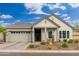 Craftsman style home with two-car garage and desert landscaping at 21354 W Minnezona Ave, Buckeye, AZ 85396