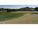 Scenic golf course view with green, sand trap, and water feature at 21354 W Minnezona Ave, Buckeye, AZ 85396