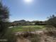 Scenic golf course with a lake and mountain backdrop at 21354 W Minnezona Ave, Buckeye, AZ 85396