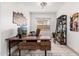 Bright home office with L-shaped desk and ladder shelving at 21354 W Minnezona Ave, Buckeye, AZ 85396
