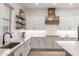 Modern kitchen with white cabinets, quartz countertops and island at 21354 W Minnezona Ave, Buckeye, AZ 85396