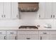 Modern kitchen with white cabinets, quartz countertops, and a gas cooktop at 21354 W Minnezona Ave, Buckeye, AZ 85396