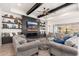Spacious living room with a fireplace, built-in shelving, and large windows at 21354 W Minnezona Ave, Buckeye, AZ 85396