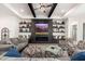 Living room features a fireplace, built-in shelving and hardwood floors at 21354 W Minnezona Ave, Buckeye, AZ 85396