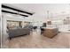 Open floor plan with hardwood floors, exposed beams, and a view of the pool at 21354 W Minnezona Ave, Buckeye, AZ 85396