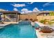 Resort-style pool and spa with outdoor kitchen and seating area at 21354 W Minnezona Ave, Buckeye, AZ 85396