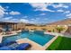 Expansive pool area with a covered patio and lush landscaping at 21354 W Minnezona Ave, Buckeye, AZ 85396