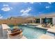 Relaxing pool and spa with fire pit and comfortable lounge chairs at 21354 W Minnezona Ave, Buckeye, AZ 85396