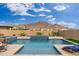 Inviting swimming pool with a water feature and mountain backdrop at 21354 W Minnezona Ave, Buckeye, AZ 85396