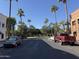 View of Verrado's town square with palm trees and parked cars at 21354 W Minnezona Ave, Buckeye, AZ 85396
