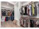 Spacious walk-in closet with custom shelving and rods at 21354 W Minnezona Ave, Buckeye, AZ 85396