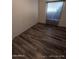 Bright bedroom with wood-look floors and neutral wall colors at 215 N Power Rd # 404, Mesa, AZ 85205