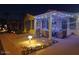 Inviting front yard with covered patio, string lights, and landscaping at night at 215 N Power Rd # 404, Mesa, AZ 85205